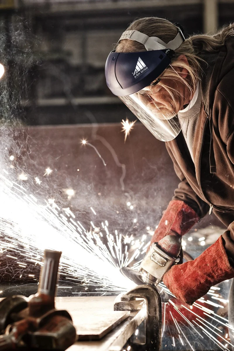 factory-worker-grinding-a-steel-edge-in-a-sheet-metal-factory